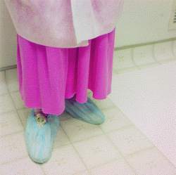 Shoes are covered with disposable covers to guard against contamination